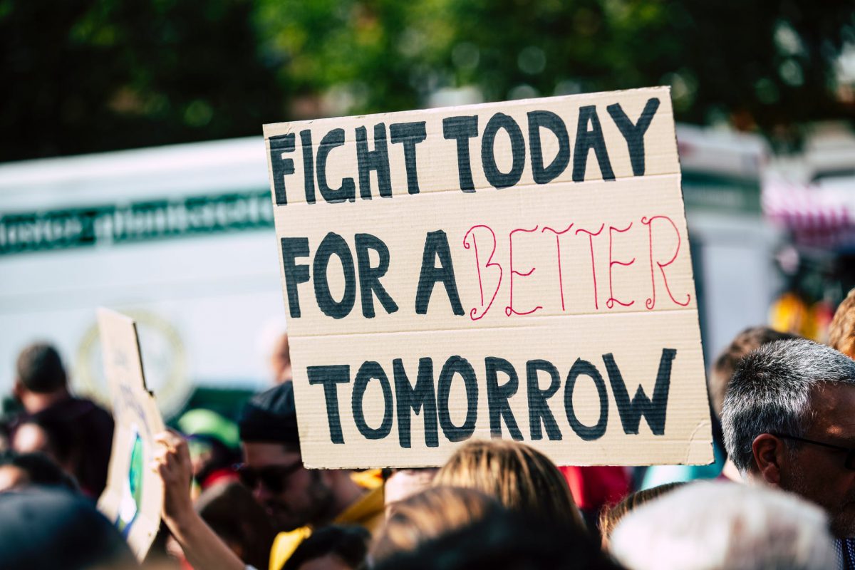 Cardboard sign reading 'Fight today for a better tomorrow'